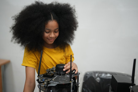 Multiracial schoolkids learning using gadgets and building robots on software robotics engineering class. Elementary school technologies science classroom. STEM education concept.の写真素材