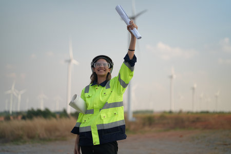 Engineer working at alternative renewable wind energy farm - Sustainable energy industry conceptの写真素材