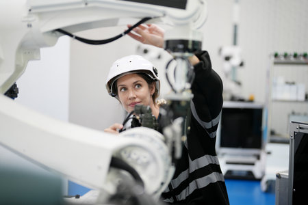Robotic Arm engineer check on equipment in its with software of an Artificial Intelligence Computer Processor Unit. High Tech Robotic Arm with an Artificial Intelligence Computer Processor Unit in its.の写真素材