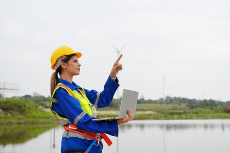 Engineer working at alternative renewable wind energy farm - Sustainable energy industry conceptの写真素材