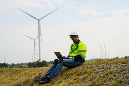 Engineer working at alternative renewable wind energy farm - Sustainable energy industry conceptの写真素材