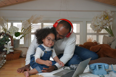 Shot of joyful parents with their little daughter sitting on floor inside living room in sunny day.. Little girl with special needs enjoy spending time with family.の写真素材