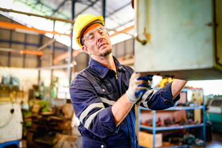 Lathe Operators Concentrated on Work. Worker in uniform and helmet works on lathe, factory....