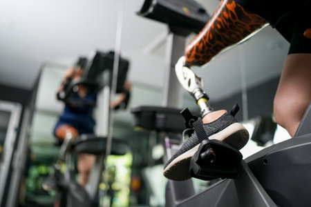 Portrait of disabled athlete woman with prosthetic leg in fitness gym
