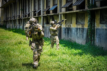 United States Army ranger during the military operation. Professional marine soldiers training with weapon on a military range.の写真素材
