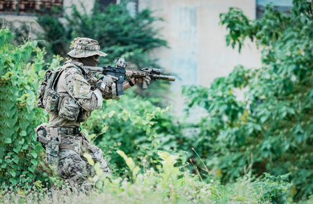 United States Army ranger during the military operation. Professional marine soldiers training with weapon on a military range.の写真素材
