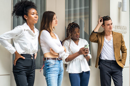Group of young multiethnic business people using mobile phone in officeの写真素材