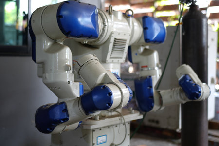 Robotics engineer working on maintenance of robotic arm in factory warehouse. Business technology.の写真素材