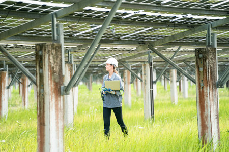 Engineer hand is installing and checking an operation of sun and cleanliness of photovoltaic solar panels, Engineer with energy measurement tool photovoltaic modules for renewable energyの写真素材