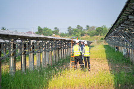 Engineer hand is installing and checking an operation of sun and cleanliness of photovoltaic solar panels, Engineer with energy measurement tool photovoltaic modules for renewable energyの写真素材