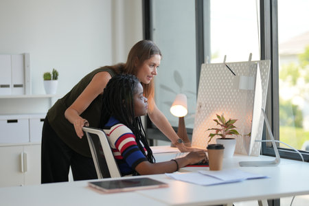 Side view of a young businesswoman working at her desk in the office