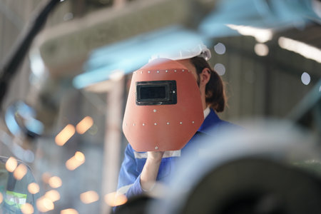 Robotics engineer working on maintenance of robotic arm in factory warehouse. Business technology.の写真素材
