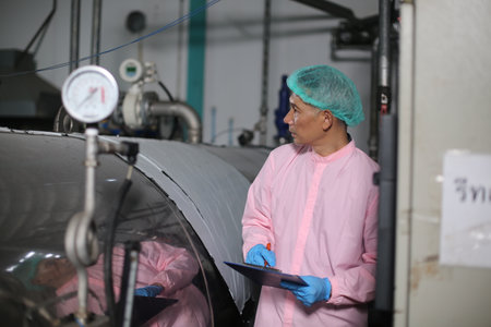 young man works in a factory for the production of alcoholic beverages