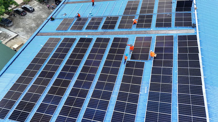Aerial view of solar photovoltaic panels for producing clean ecological electricity on the roof of a...