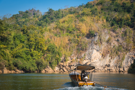 A man driving a boat on the Riverの写真素材