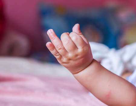 Small delicate little hand of newborn - close portraitの写真素材