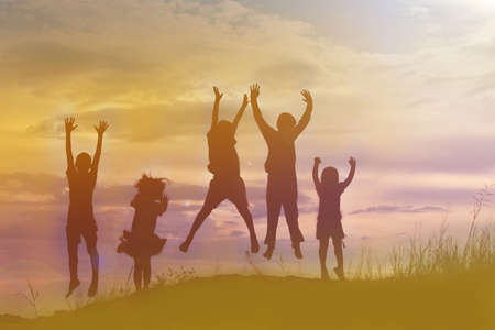 silhouette of a happy children and happy time sunsetの写真素材