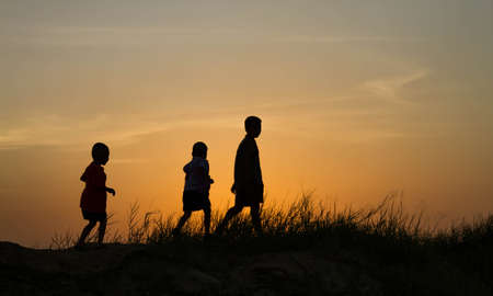 silhouette of a happy children and happy time sunsetの写真素材