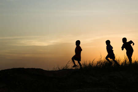 silhouette of a happy children and happy time sunsetの写真素材