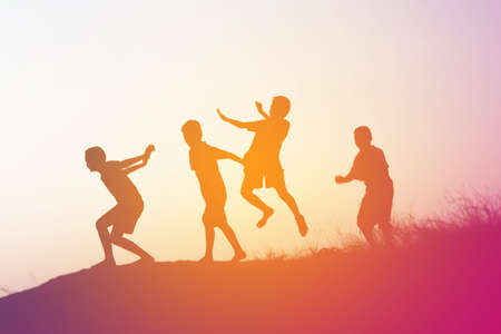 silhouette of a happy children and happy time sunsetの写真素材