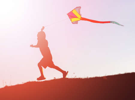 silhouette of a happy children and happy time sunsetの写真素材