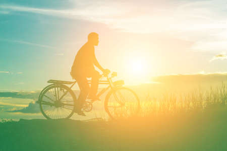 silhouette of bicycle with manの写真素材