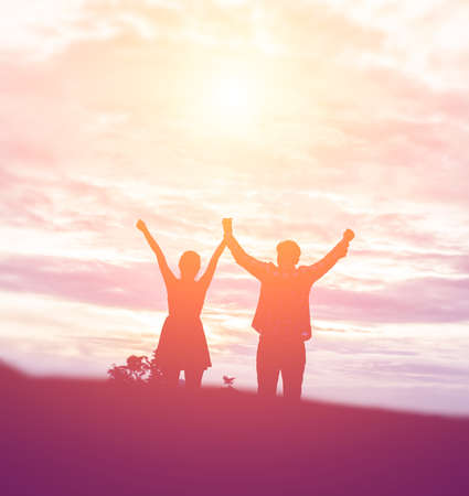 Silhouette a happy couple holdingの写真素材