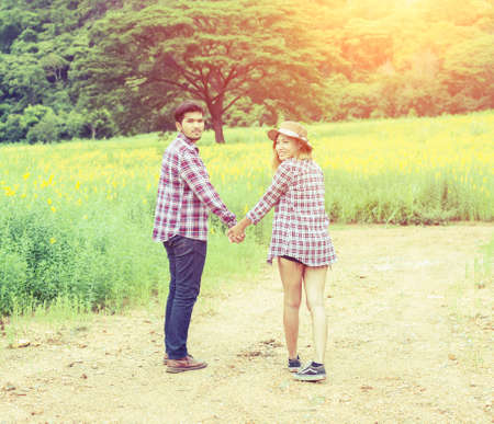 A young couple holding hands. In Nature sunriseの写真素材