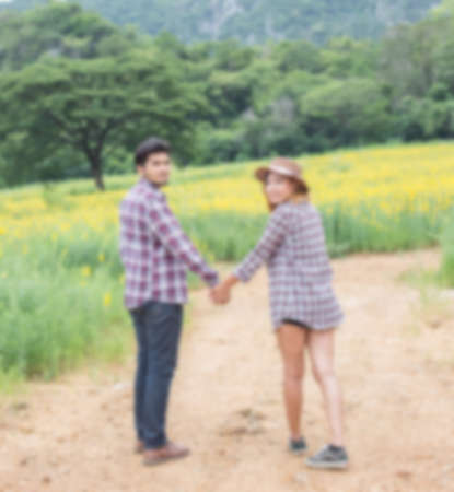 A young couple holding hands. In Nature sunriseの写真素材