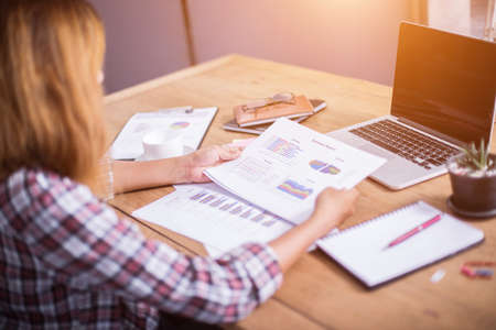 Business Woman Writing with pen in notepad on workplace.の写真素材