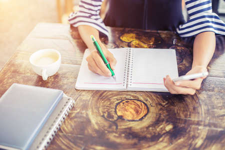 Image of document with charts on background of male and female working , business conceptの写真素材