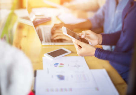 Business team working on laptop, while sitting at office. Business people.の写真素材