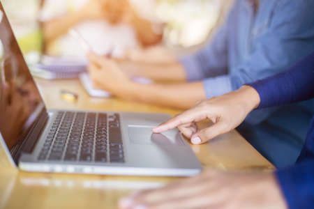 Business team working on laptop, while sitting at office. Business people.の写真素材