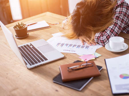 Young business woman tired and headache about her work.