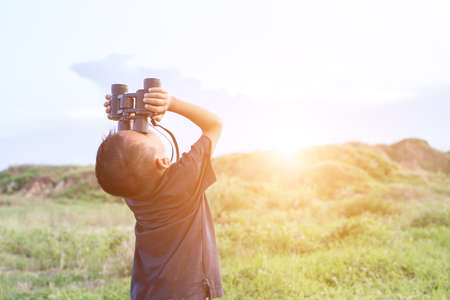 Happy kid playing outdoors. Travel and adventure conceptの写真素材