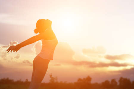 Young woman raise hands up for her success, Concept of Success in life.の写真素材