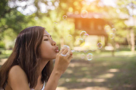 a beautiful woman blowing bubblesの写真素材