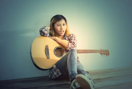Hipster woman style portrait enjoy with guitar look so happy.