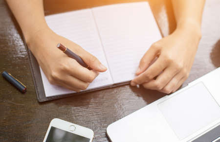 Image of document with charts on background of male and female working , business conceptの写真素材