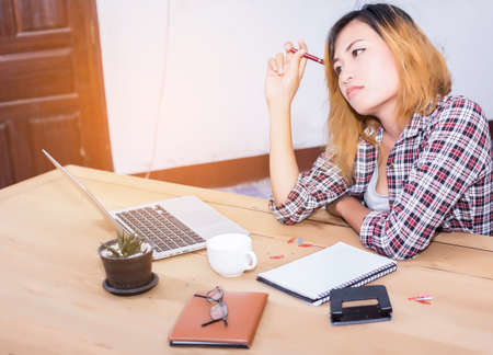 business woman writing something on notepad in office.
