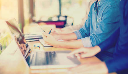 Business team working on laptop, while sitting at office. Business people.の写真素材