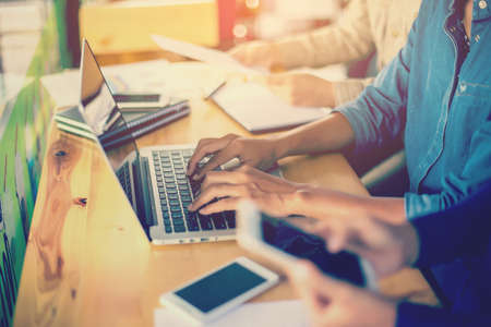 Business team working on laptop, while sitting at office. Business people.の写真素材