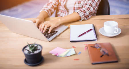 business woman writing something on notepad in office.の写真素材