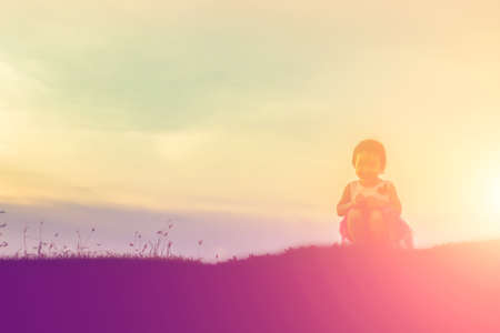 kid silhouette,Moments of the child's joy. On the Nature sunsetの写真素材