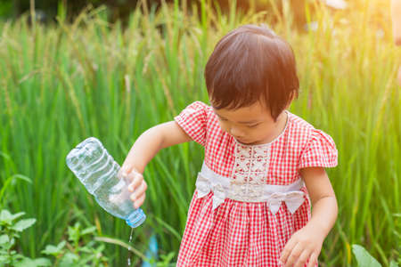 Lovely little girl drinking waterの写真素材