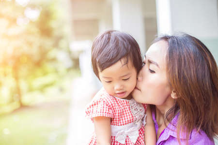 Mother holding her daughterの写真素材