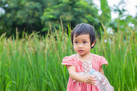 Lovely little girl drinking waterの写真素材