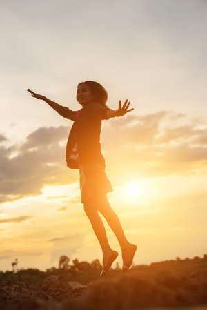 Young woman raise hands up for her success, Concept of Success in life.の写真素材