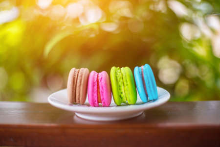 valentine macaroons with coffee on wooden table. Toned imageの写真素材