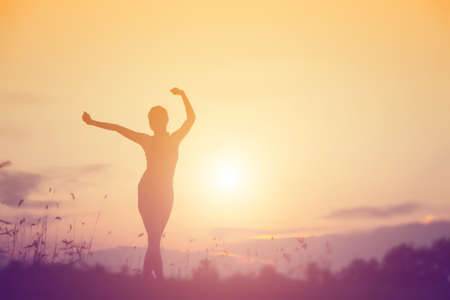 Young woman raise hands up for her success, Concept of Success in life.の写真素材